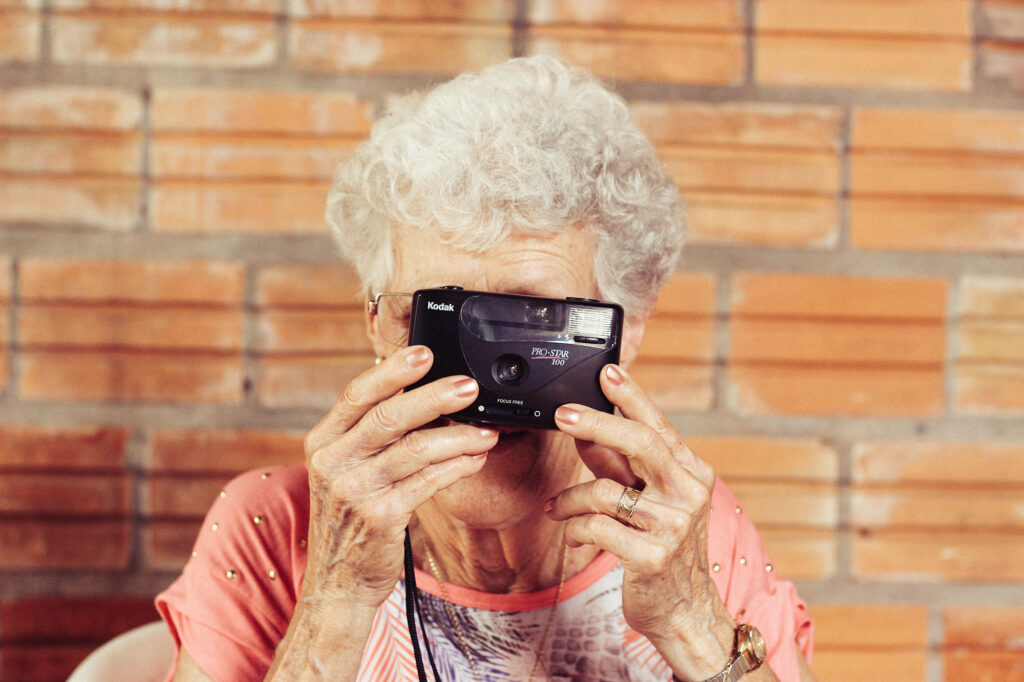 senior woman holding camera
